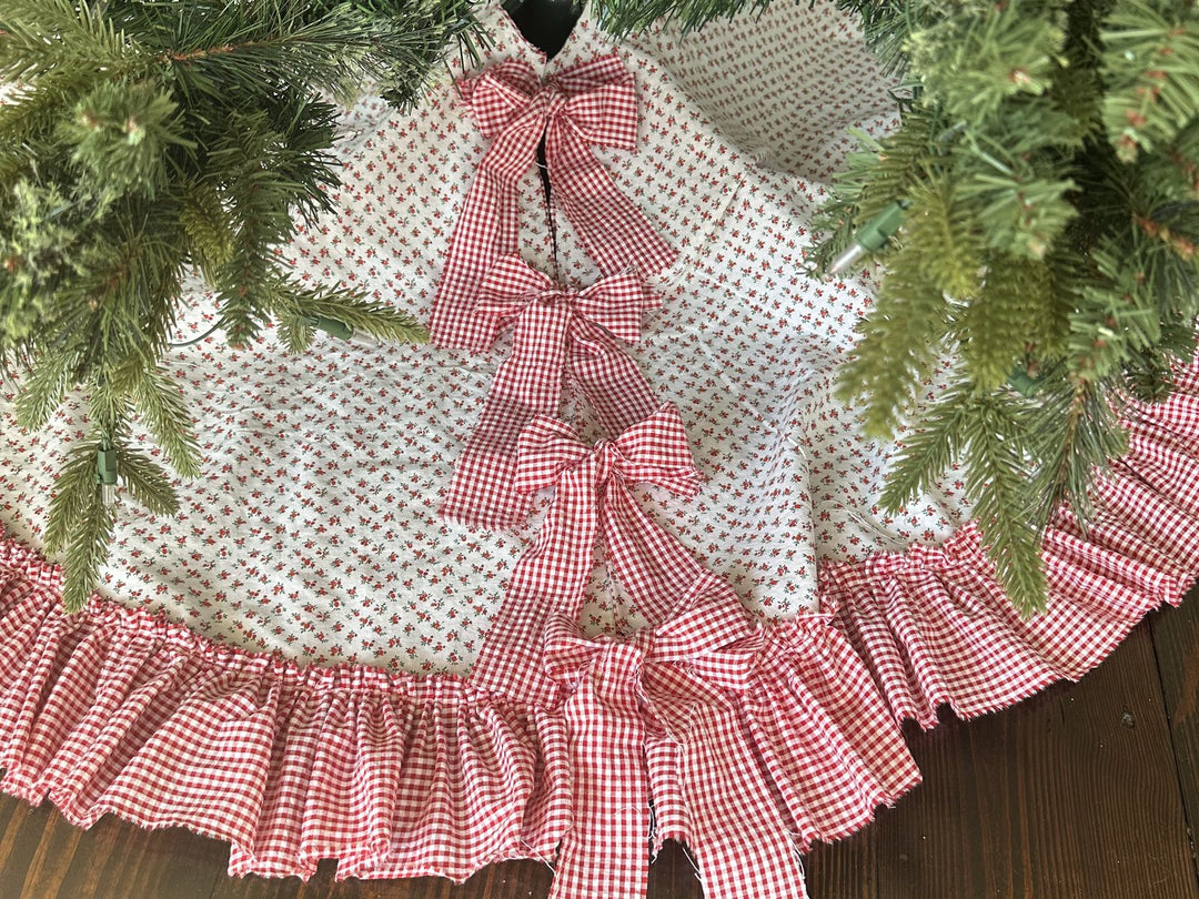 Red gingham ruffled Christmas tree skirt with gingham bows, a Pike Road Arts & Crafts Fair exclusive from High Cotton Textile, Booth 121