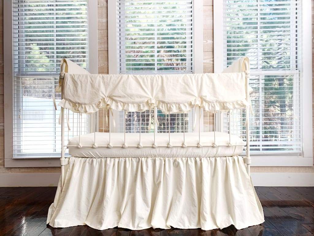 Gender neutral nursery with a white crib in ivory scalloped crib rail cover, farmhouse crib skirt and fitted sheet, handmade in Alabama by High Cotton Textile