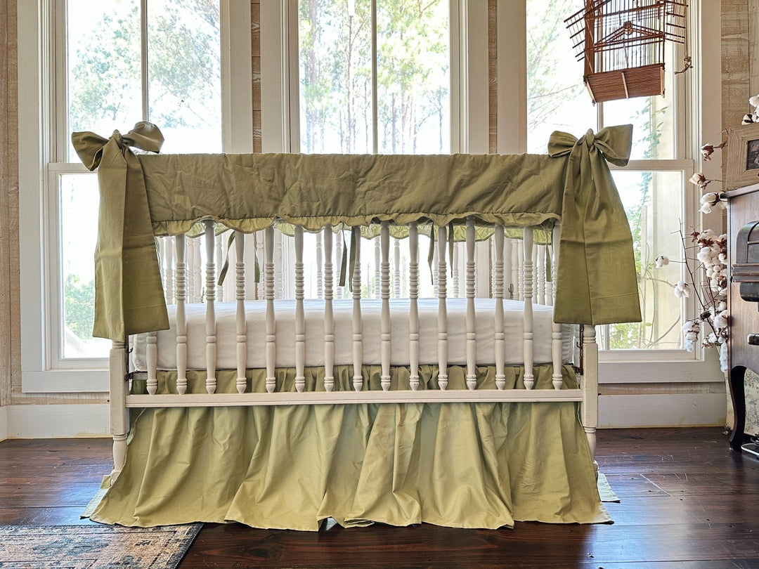 Sage green nursery with a crib in a sage ruffled rail cover, farmhouse crib skirt and large bow, handmade in Alabama by High Cotton Textile