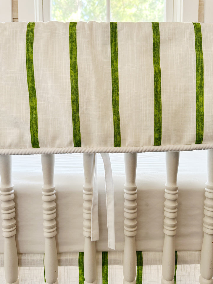 Close view of the brushed green stripes, the white cording along the bottom edge and one slim white tie