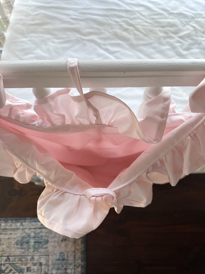 Looking down into the deep pink pouch of the ruffled caddy, the ruffle edging the opening