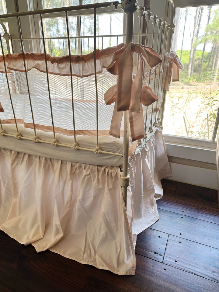 Top-down view of crib liners inside crib, showing breathable mesh and ruffle edges