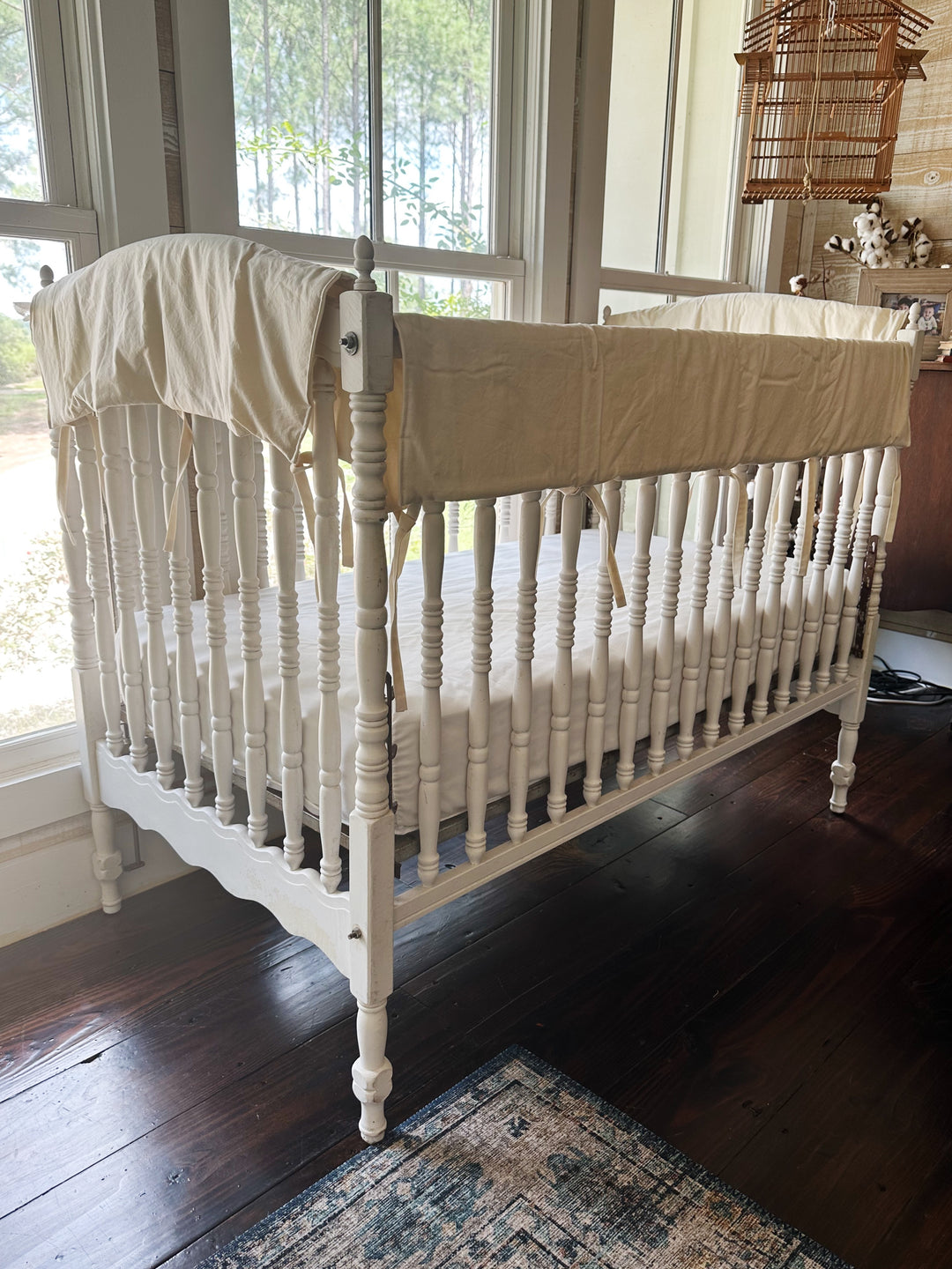 Natural crib rail covers styled on all four top rails in a neutral farmhouse nursery