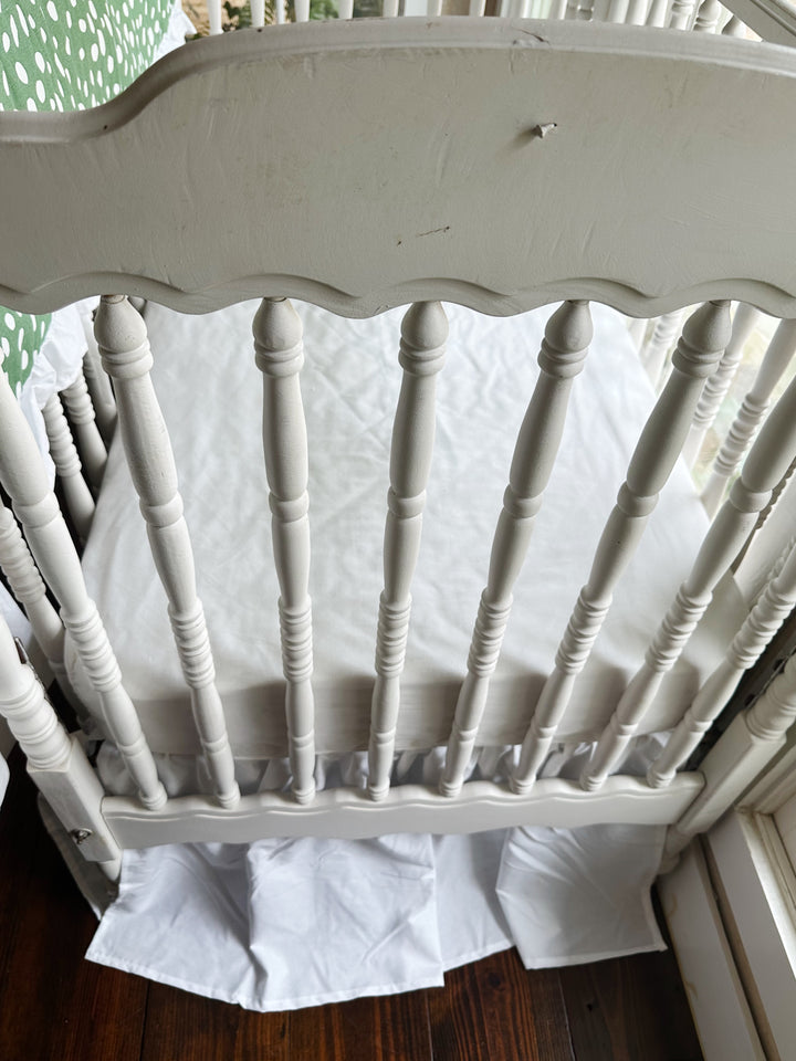 Foot of the crib with the white farmhouse skirt at a 20-inch drop