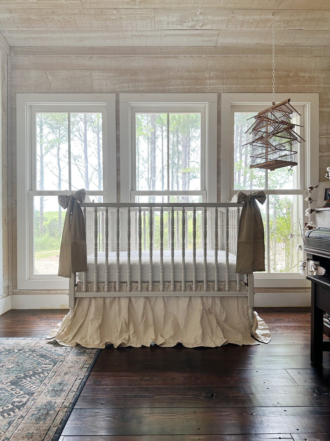 Large oatmeal crib bow paired with a natural osnaburg ruffled crib skirt - High Cotton Textile