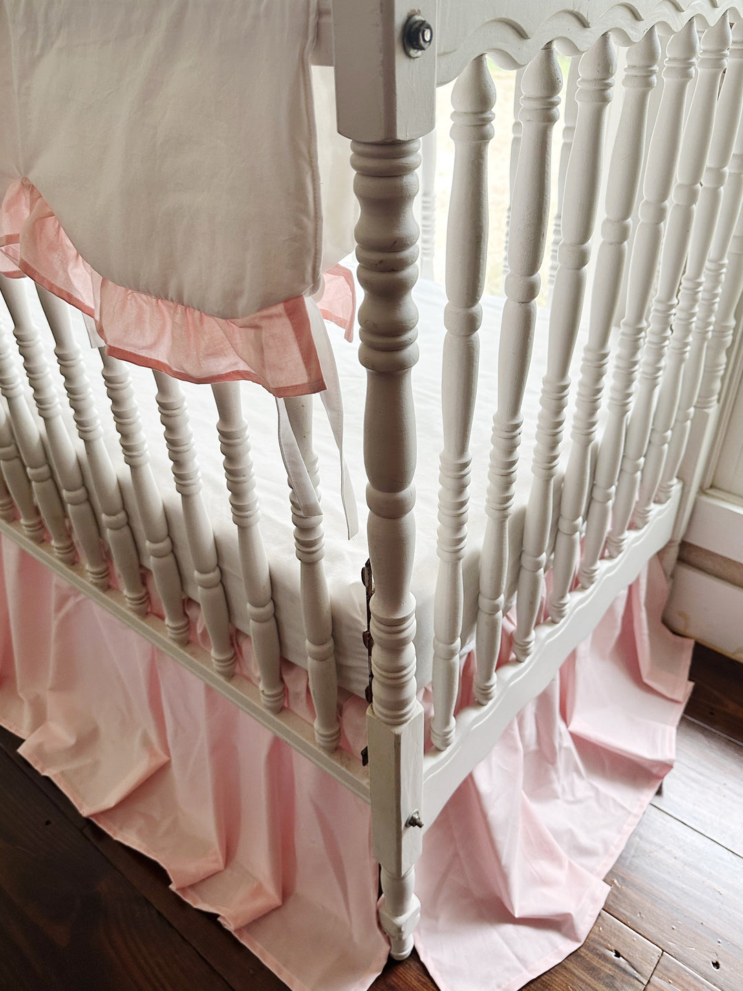 Sisters Pink ruffle trim and white cotton ties at the end of the scalloped crib rail cover