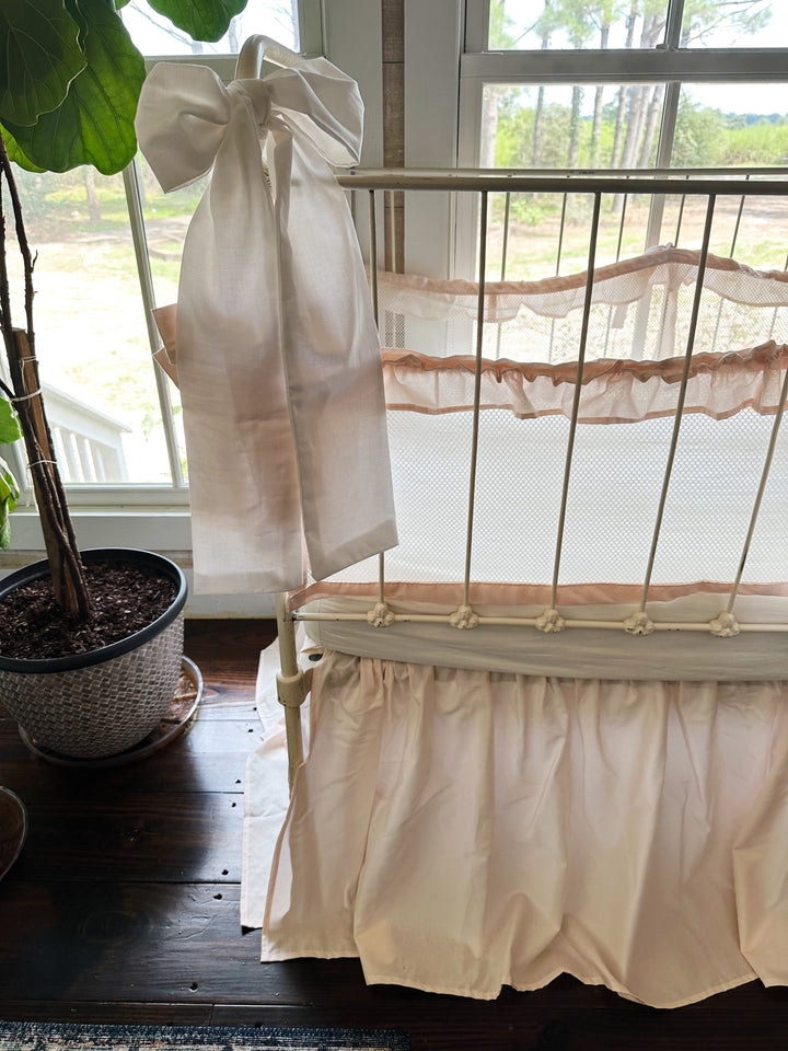 Tied crib liner showing secure crib rail attachment