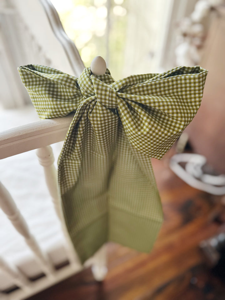 Large pine green gingham crib bow sash tied to a white crib rail