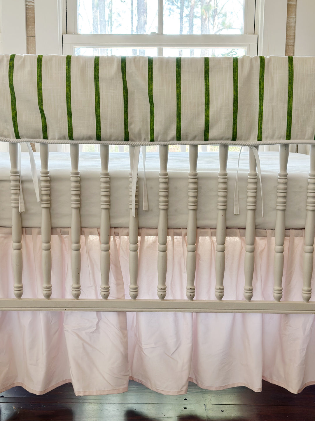 Close view of the brushed green stripes, the white cording edge and the slim white ties over the pink skirt