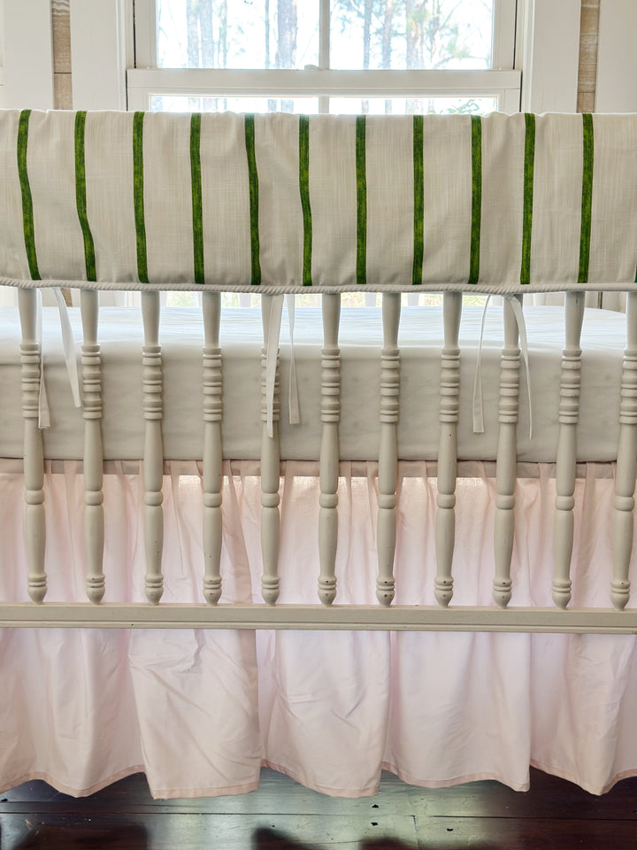 Close view of the brushed green stripes, the white cording edge and the slim white ties over the pink skirt