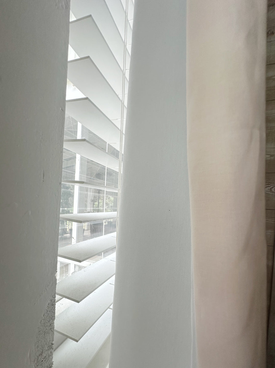 Edge of a Ballet Slipper Pink panel beside its white lined back, with window blinds behind