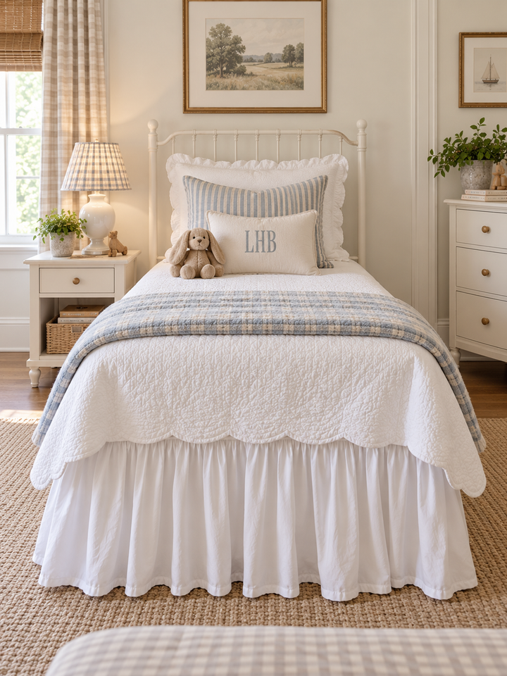 Straight on view from the foot of an iron bed showing the white farmhouse twin bed skirt - High Cotton Textile