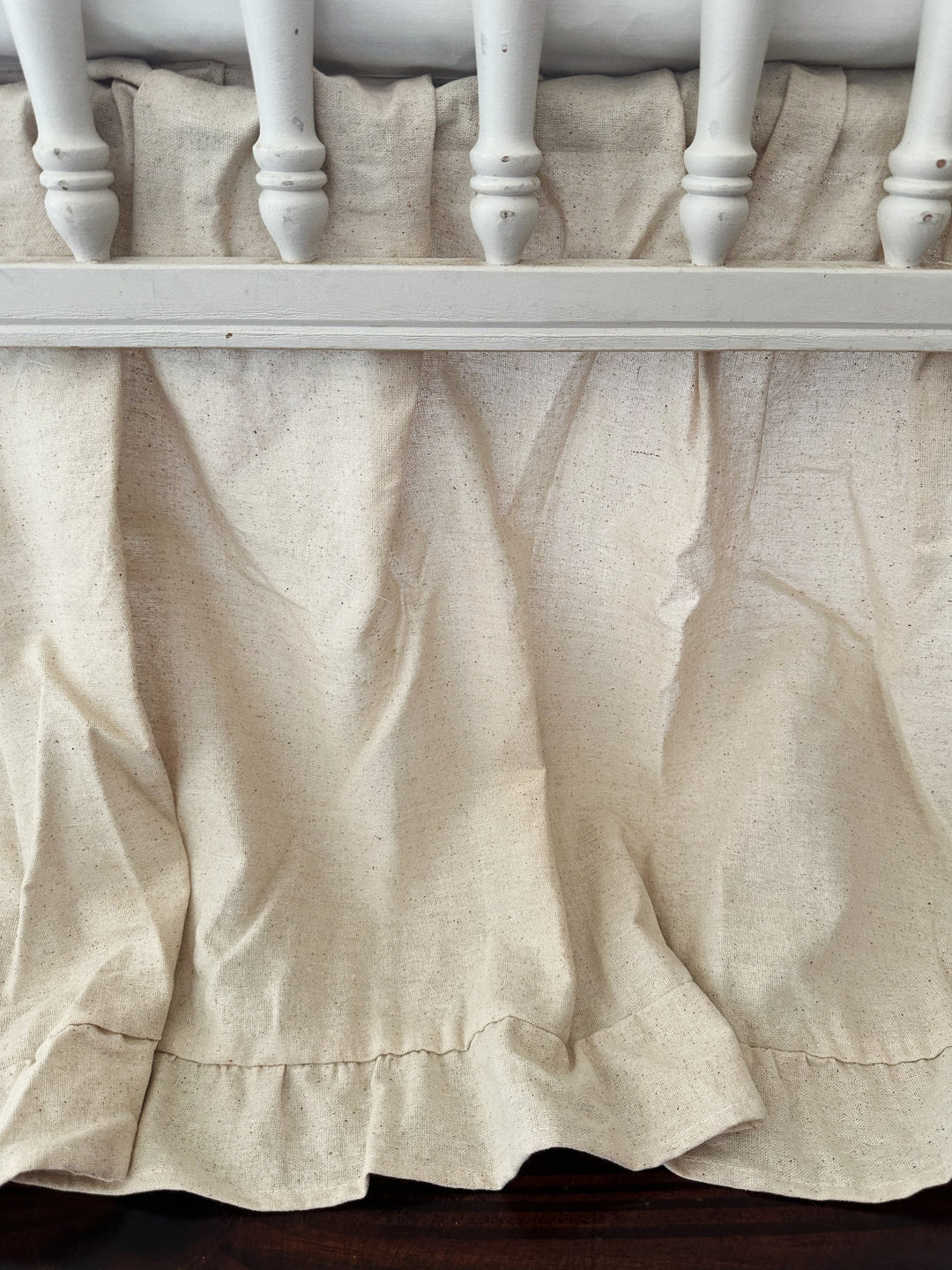 Gender neutral ruffled crib skirt in natural osnaburg styled in a nursery - High Cotton Textile