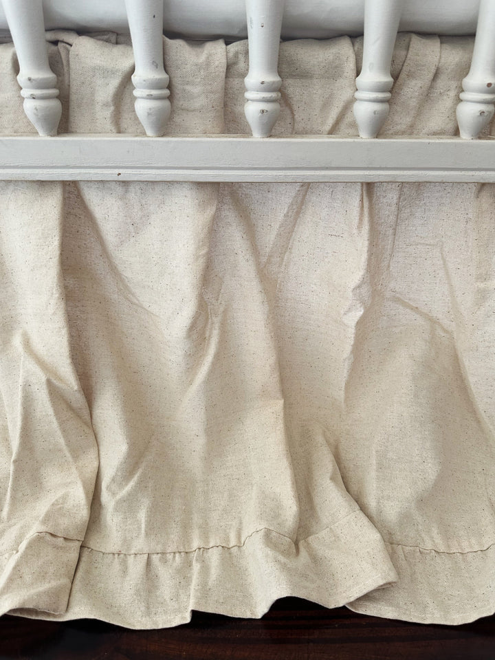 Gender neutral ruffled crib skirt in natural osnaburg styled in a nursery - High Cotton Textile