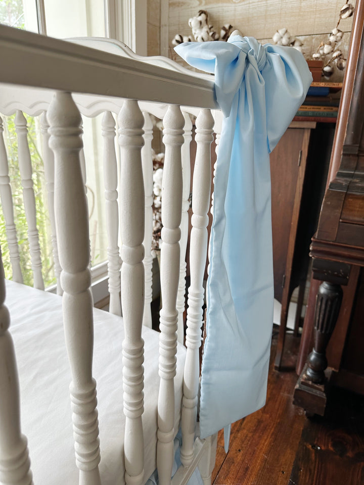 Side view of the bow on the crib rail showing how far the tails hang
