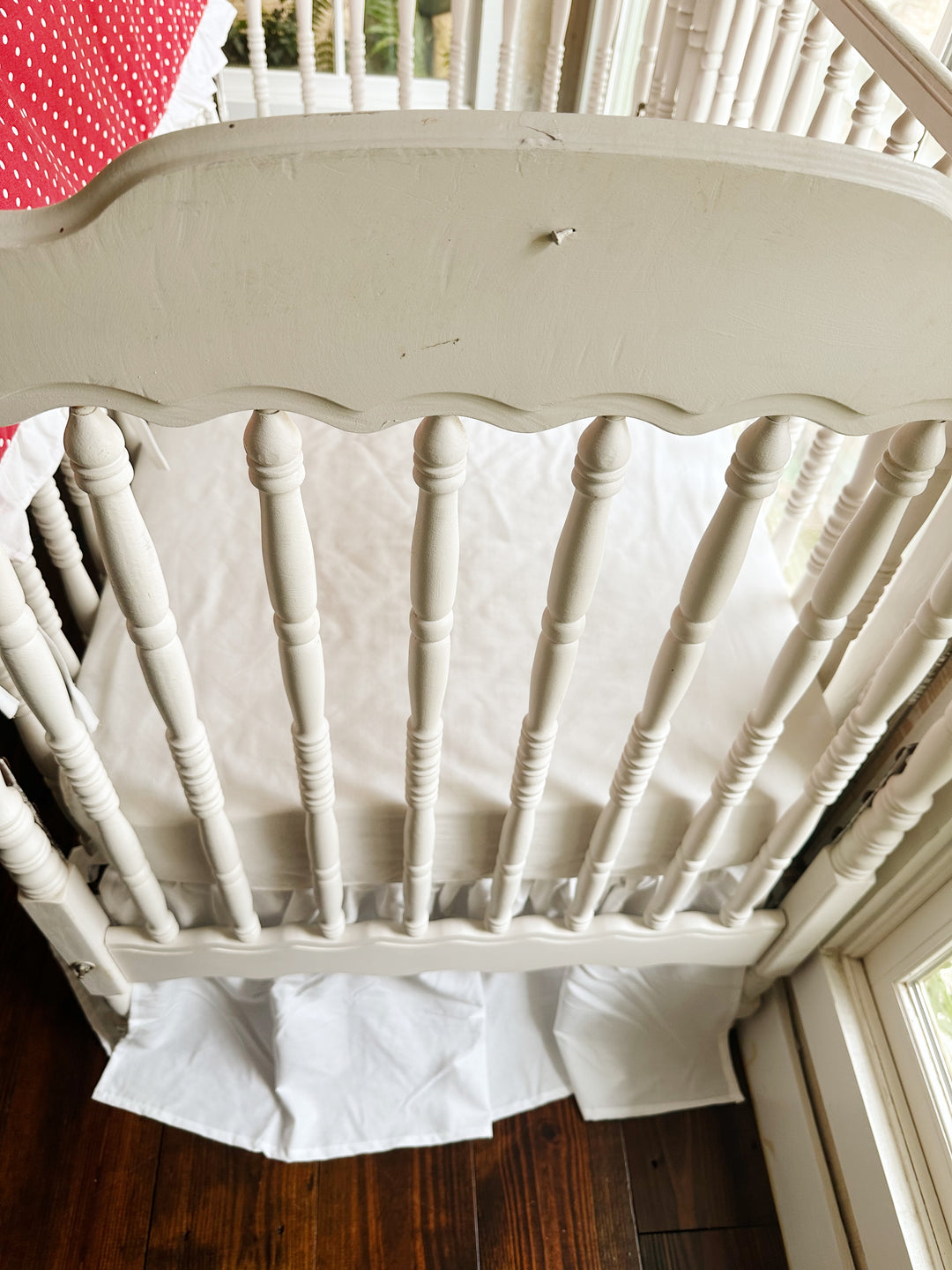Foot of the crib with the white farmhouse skirt at a 20-inch drop