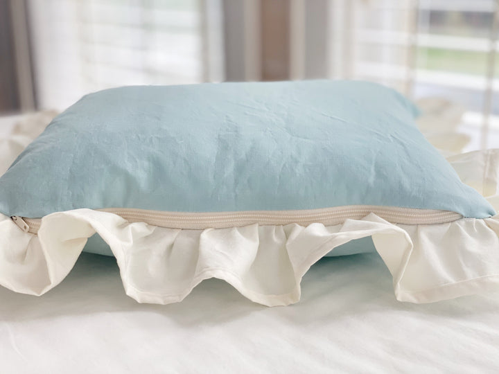 Side view of the mist crib pillow showing the zipper and ruffle depth