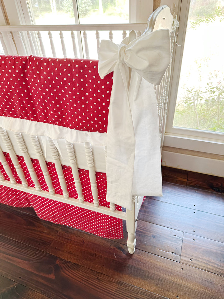 White sash hanging the length of the post beside the dotted rail cover and skirt