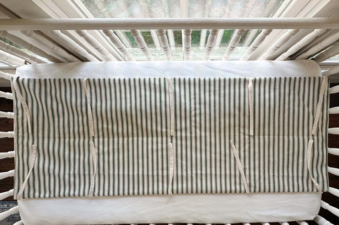 The rail cover seen from above, showing the full flat panel and the natural osnaburg ties along both edges
