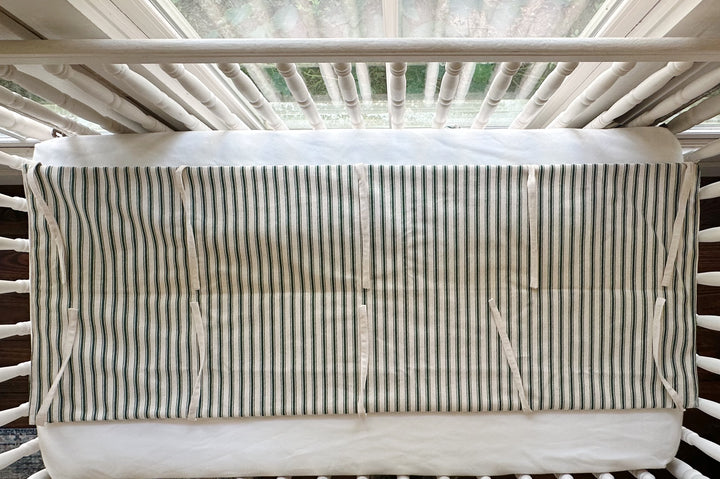 The rail cover seen from above, showing the full flat panel and the natural osnaburg ties along both edges