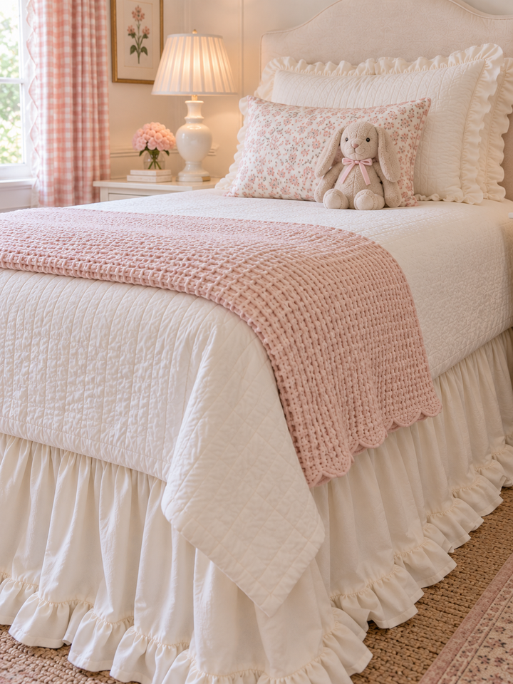 Close up of the ruffled hem and deep gathers on an ivory cotton twin bed skirt - High Cotton Textile