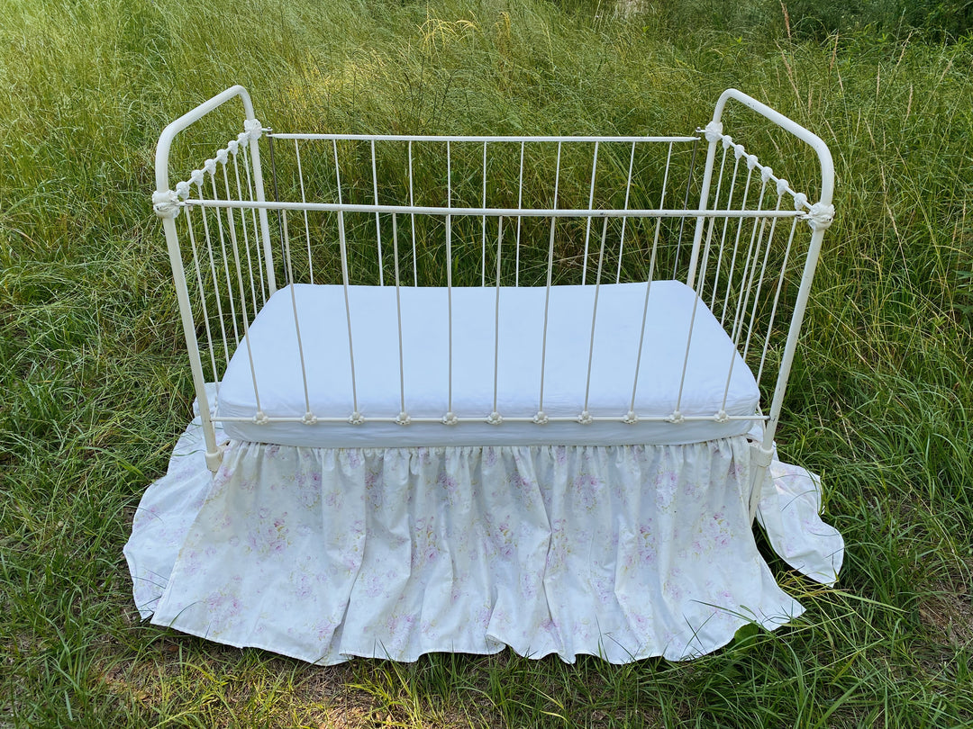 Front view of lavender floral gathered crib skirt, washed cotton, made to order