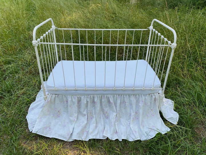 Front view of lavender floral gathered crib skirt, washed cotton, made to order
