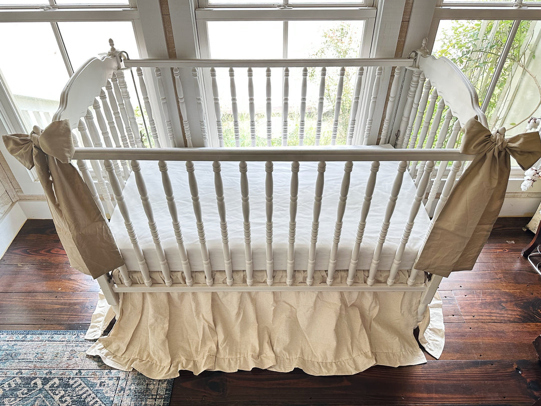 Four sided natural osnaburg ruffled crib skirt on a standard crib in a neutral nursery - High Cotton Textile