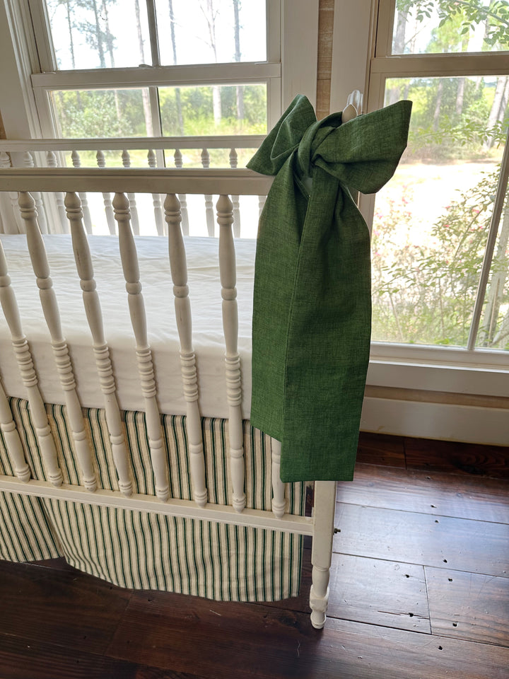 Side view of one sash falling the full length of the post past the striped skirt