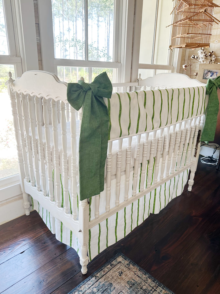 Angled view of the striped set with a cypress green sash hanging the length of the front corner post