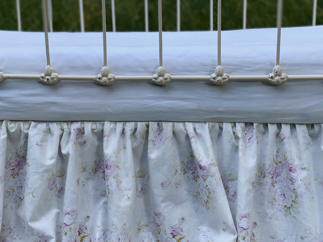 Gathered lavender floral crib skirt overhead view showing 4-sided coverage and split corners