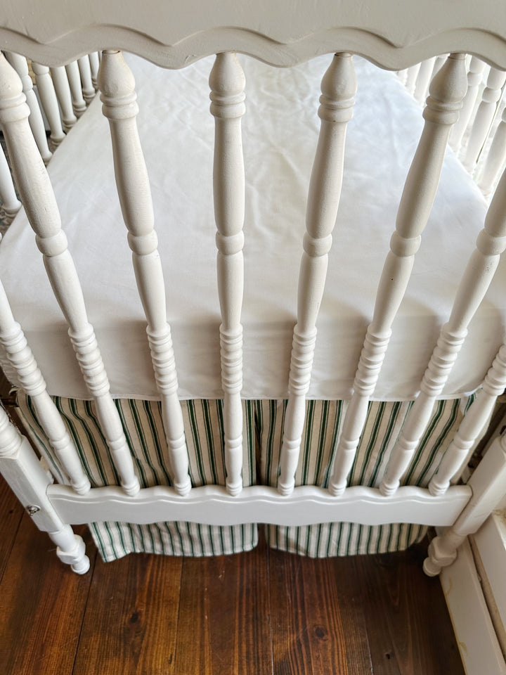Close on the scalloped end panel above the ticking skirt's center pleat