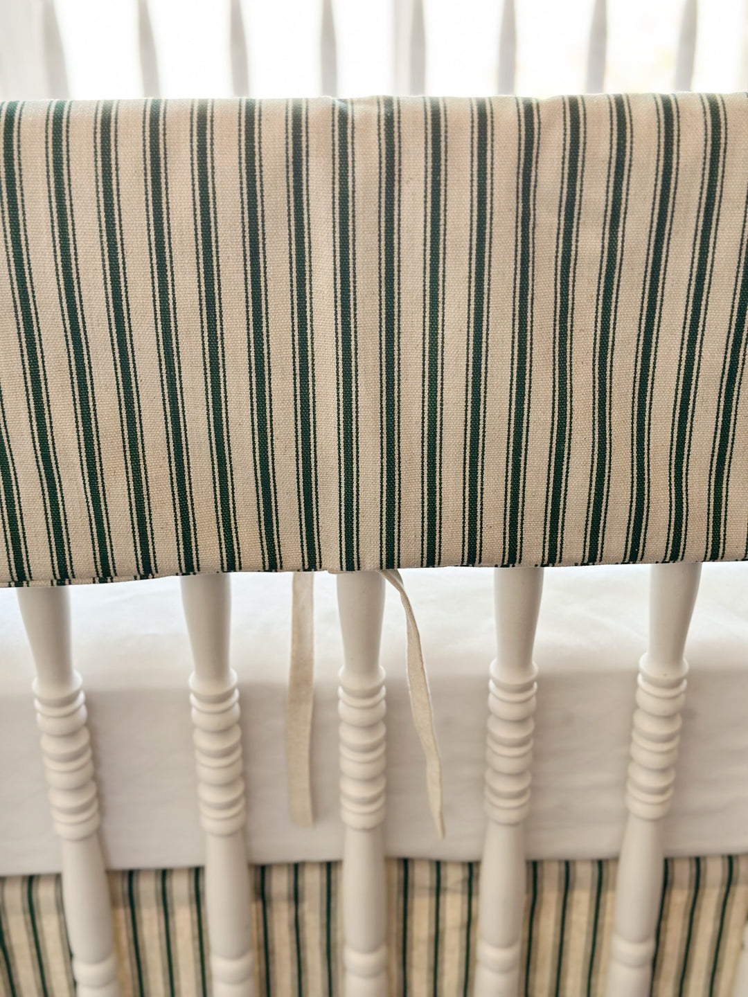 Close view of the woven green ticking stripe and a single narrow natural osnaburg tie