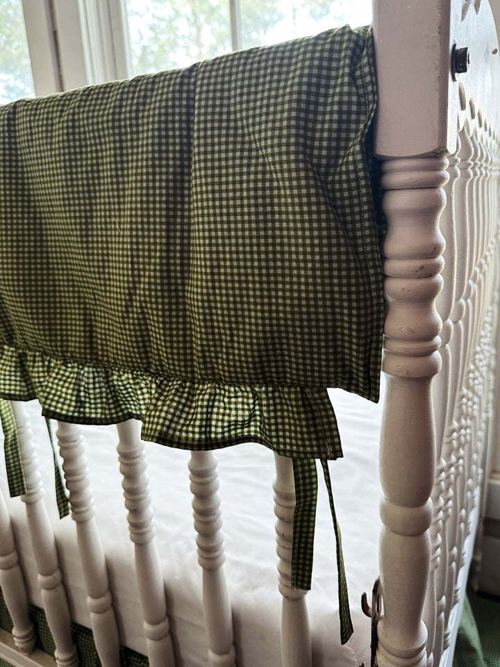 Ruffled edge and fabric tie detail on the pine green gingham crib rail cover