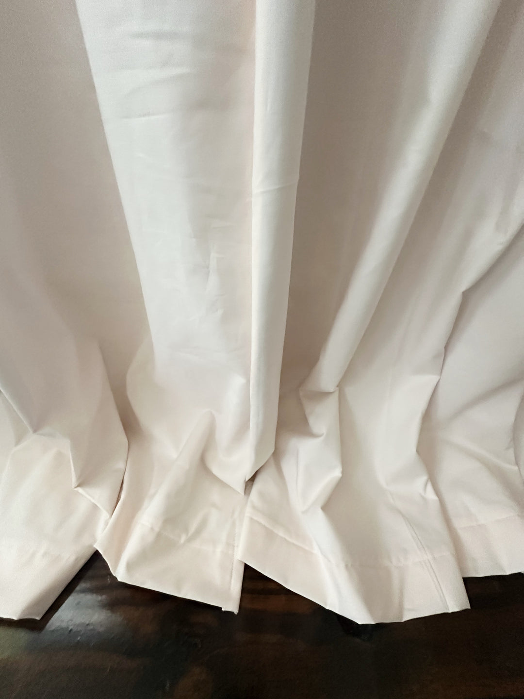 Close-up of the hemmed bottom of the Ballet Slipper Pink panel folding onto the floor