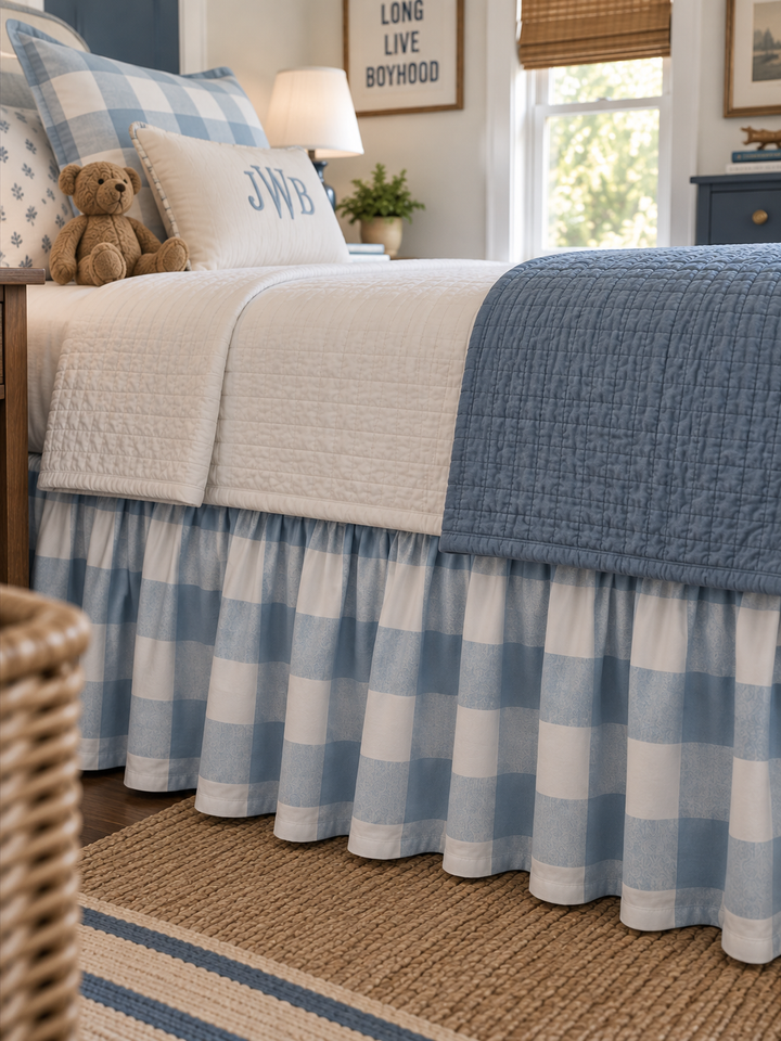 Close up of the gathered blue and white buffalo check twin bed skirt with a plain farmhouse hem - High Cotton Textile