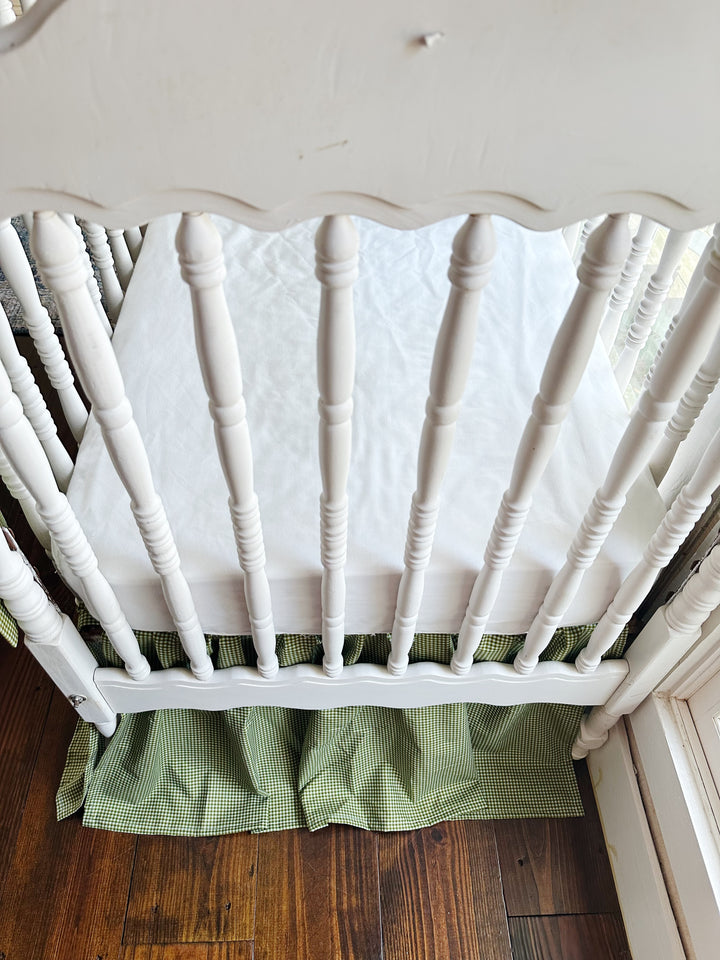 White spindle crib end with the green gingham gathered farmhouse crib skirt