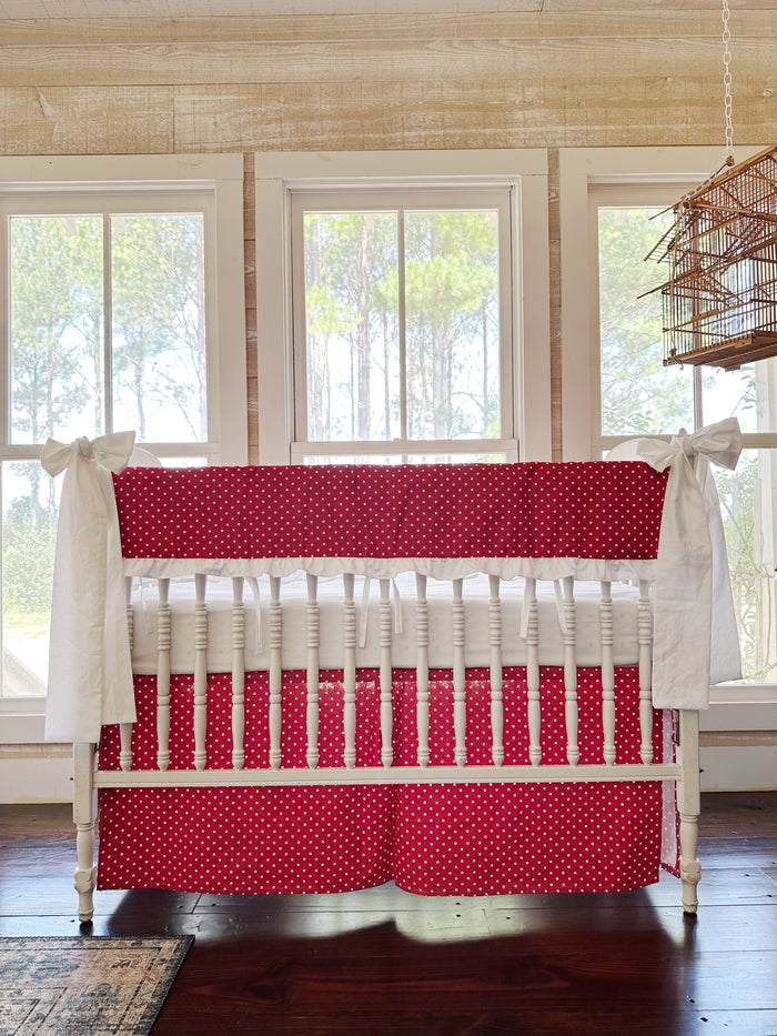 The whole crib straight on, dots on the rail cover and again on the tailored skirt