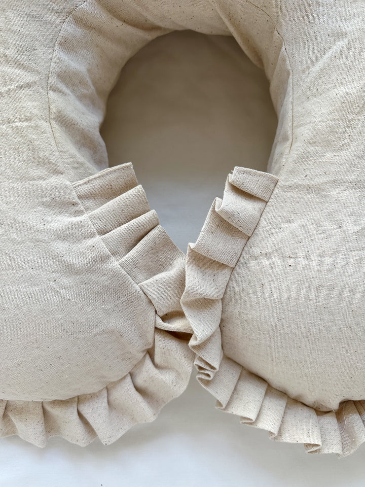 Pleated osnaburg ruffle wrapping both tips of the Natural Osnaburg Boppy cover where they meet