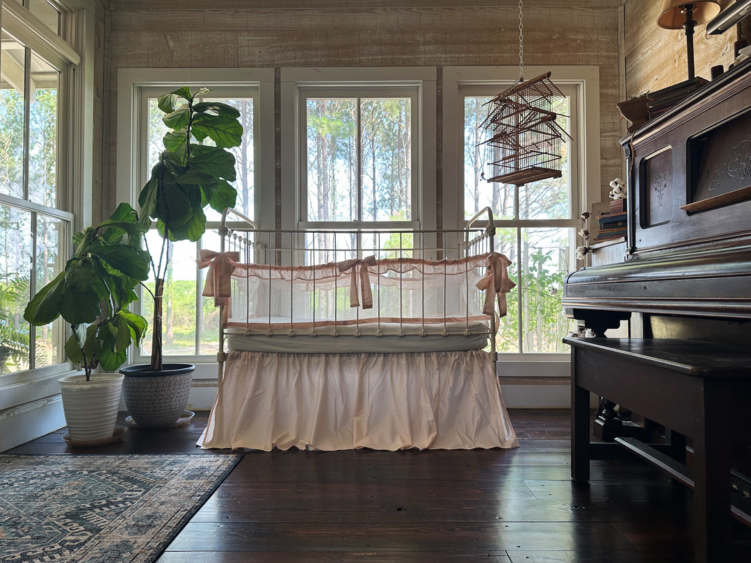 Close-up of tie closures on crib liners, showing secure attachment and handmade quality