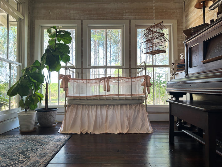 Close-up of tie closures on crib liners, showing secure attachment and handmade quality