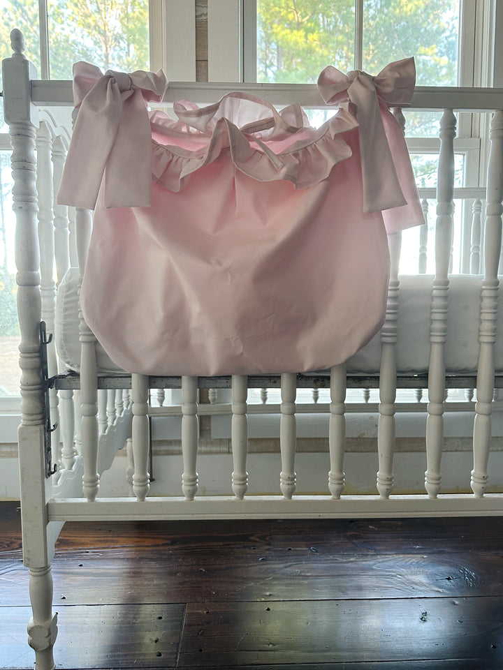 Front of the baby pink ruffled caddy with pink bows at each end and a center tie