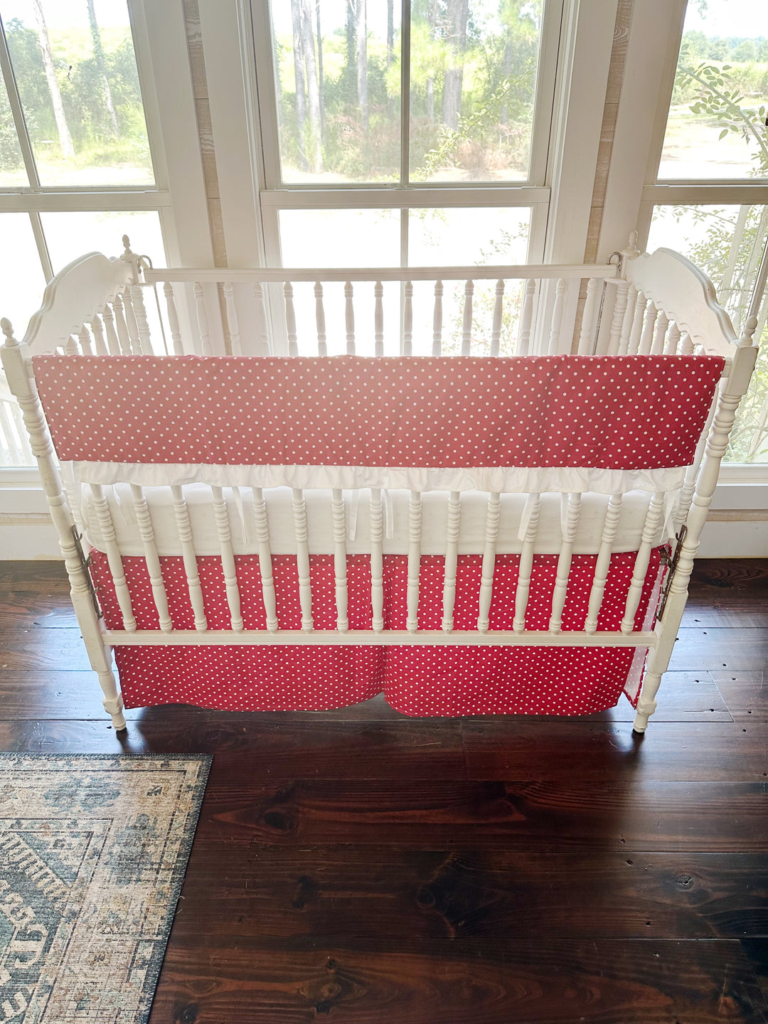 The whole crib straight on, dots on the rail cover and again on the tailored skirt