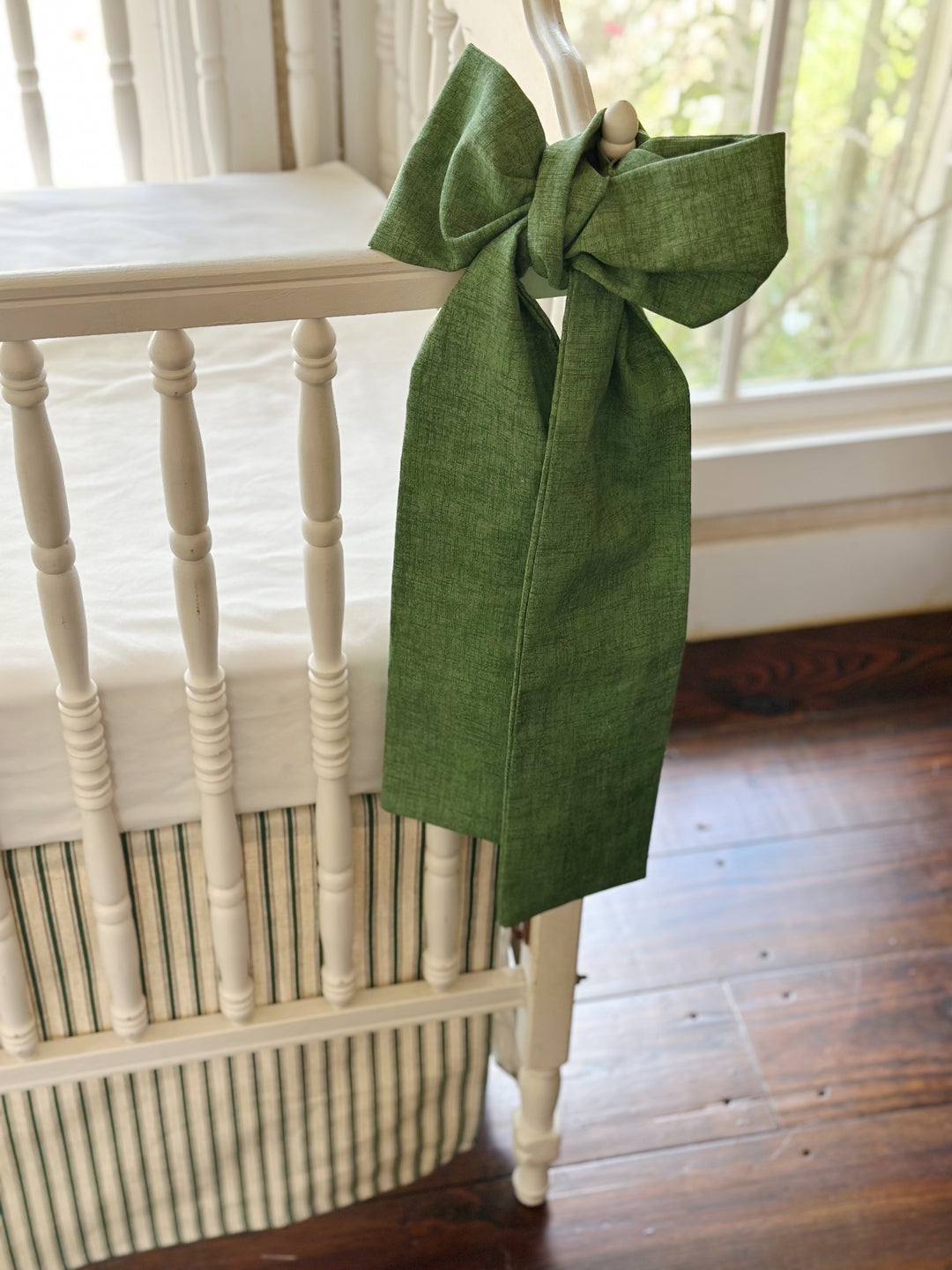 Tight crop of the green sash tails and the woven texture of the solid cypress green cotton