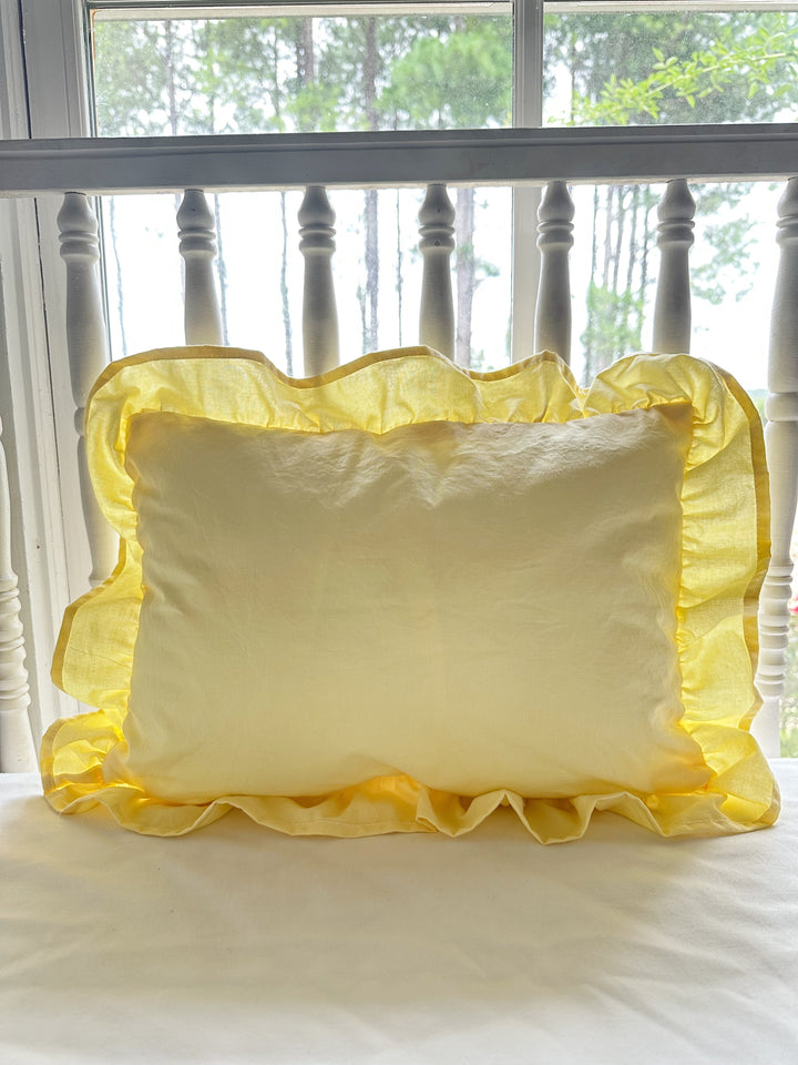Baby yellow ruffled crib pillow without monogram showing the gathered cotton ruffle border - High Cotton Textile