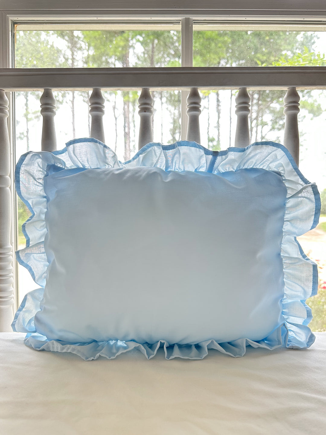 Heirloom blue ruffled crib pillow in soft washed cotton with a gathered ruffle border on all four sides - High Cotton Textile