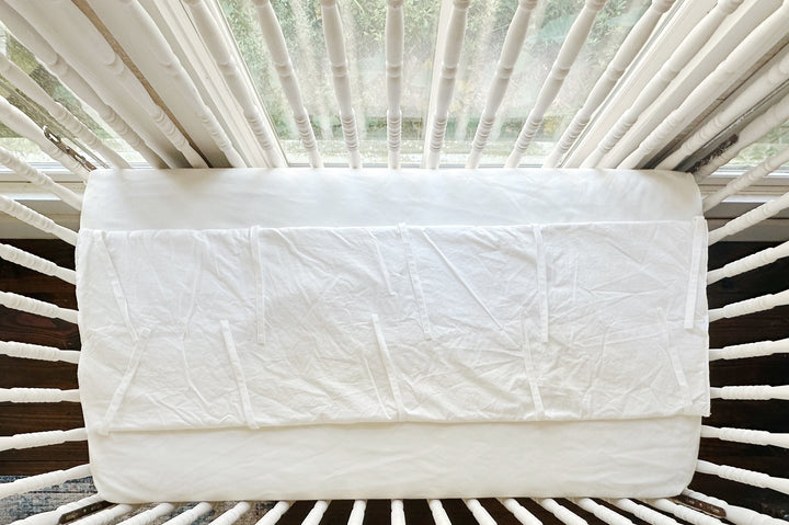 The white rail cover folded open to show the plain tailored hem and tie placement