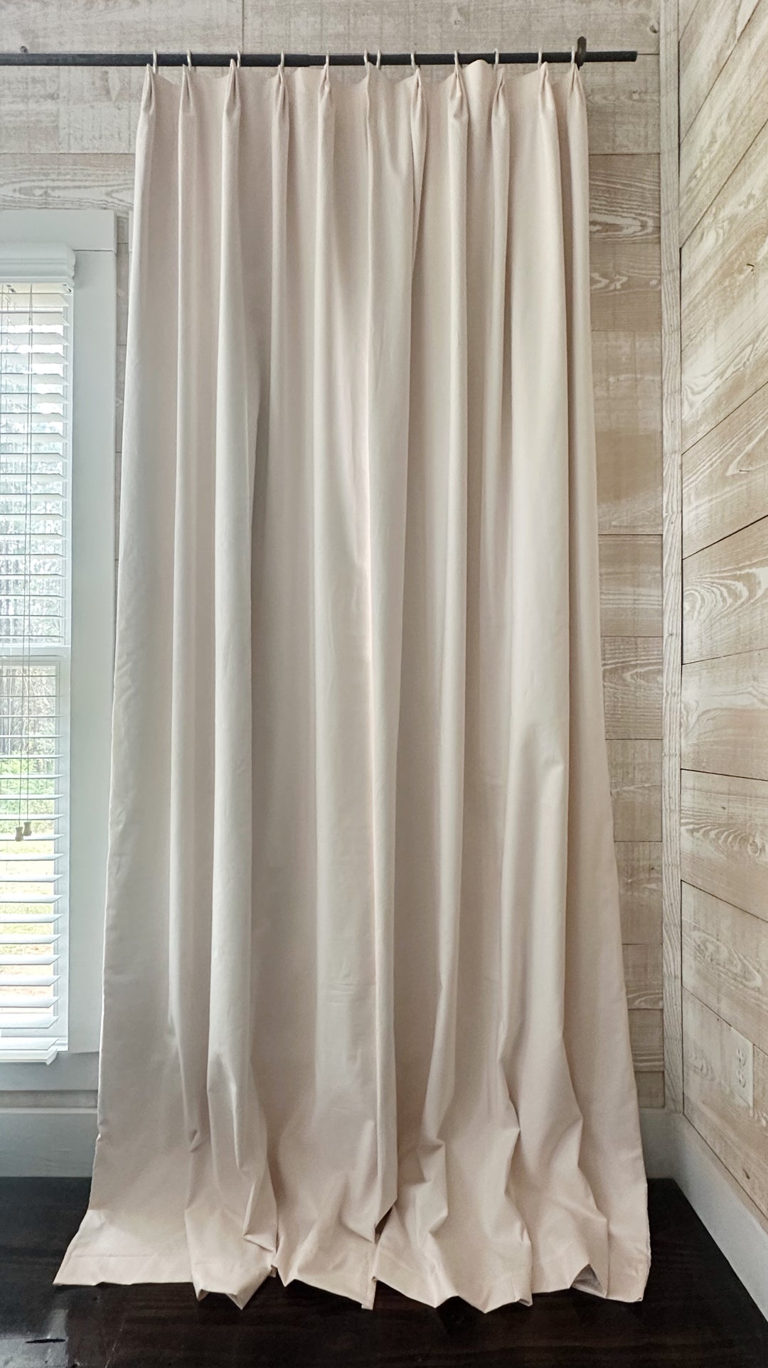 Single Ballet Slipper Pink euro pleat blackout panel drawn closed beside a window, its pleated header hung from white curtain rings