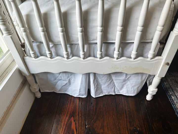 Pleated center panel and split corner detail on white cotton crib skirt