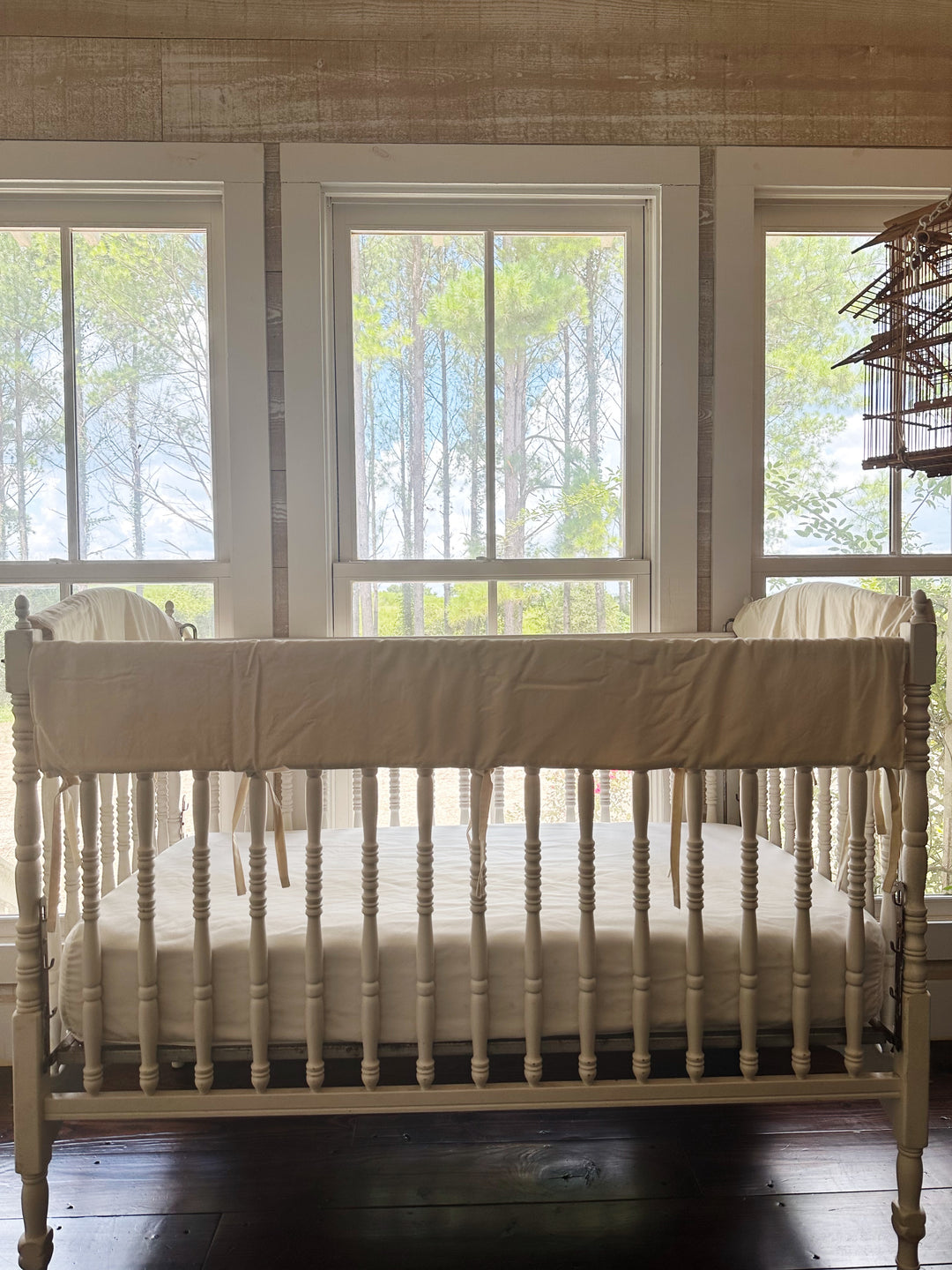 Gender neutral Natural crib rail cover set on a white heirloom crib in a bright nursery